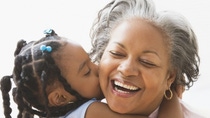 Cheerful senior lady cuddling with her granddaughter. Cheerful senior lady cuddling with her granddaughter.