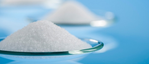 White supersorbent polymers as a fine powder on a blue background.