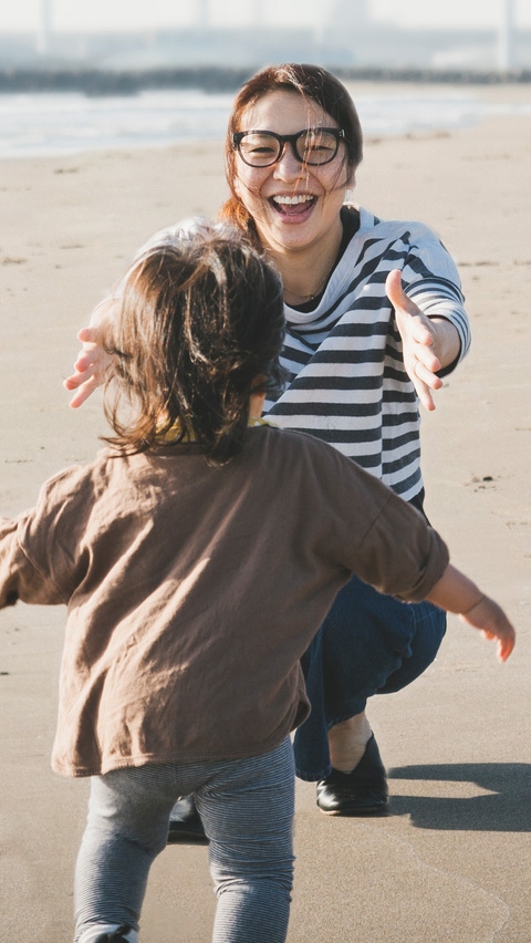 A woman and a toddler on the beach A woman and a toddler on the beach